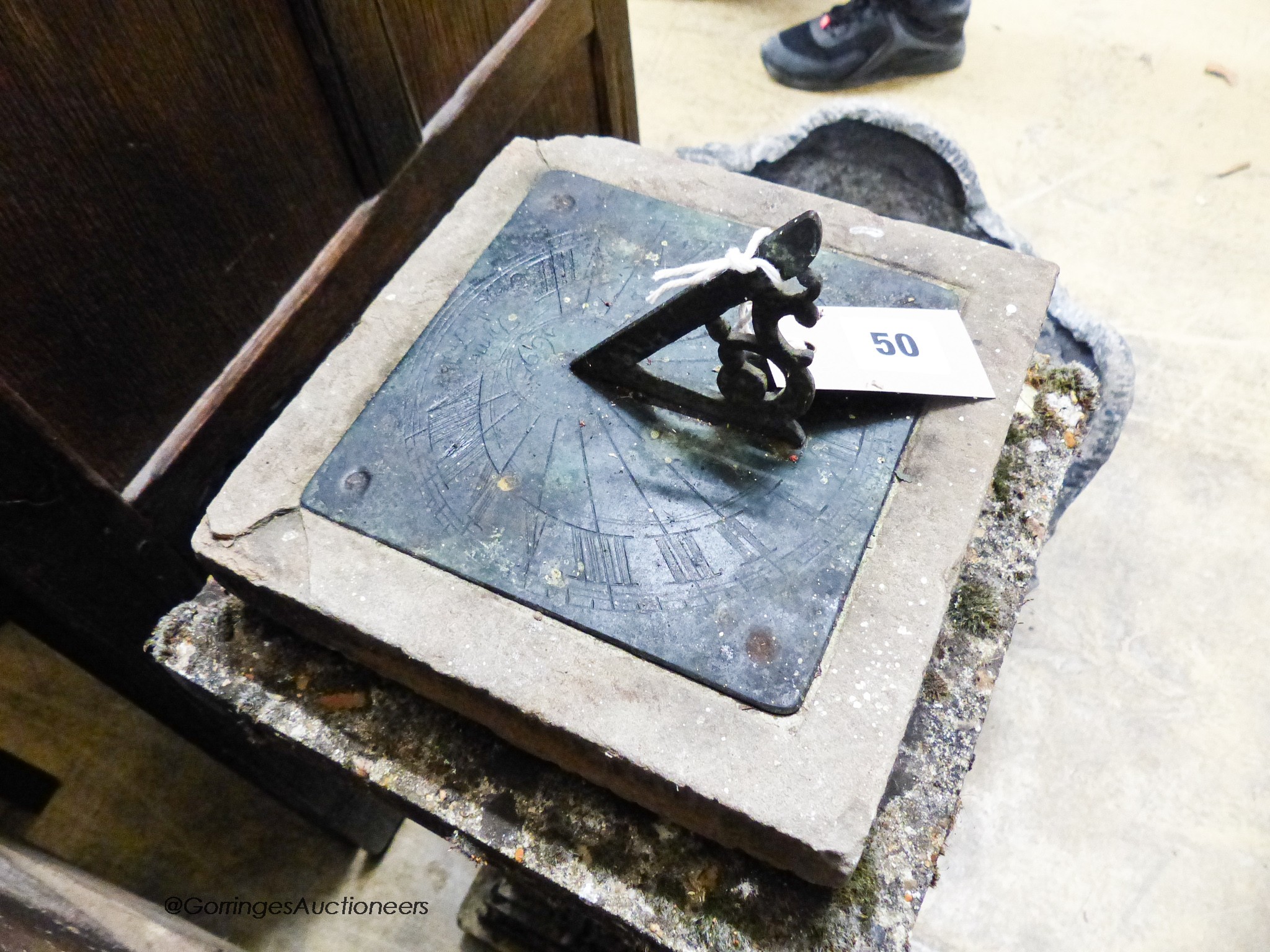 A copper sundial on reconstituted stone plinth, height 73cm together with a circular cast lead planter, diameter 43cm